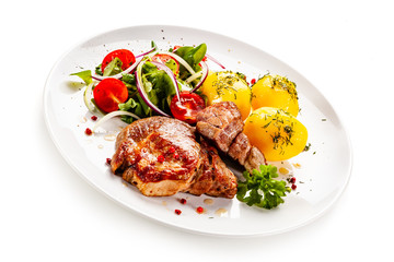 Grilled steak with boiled potatoes and vegetable salad