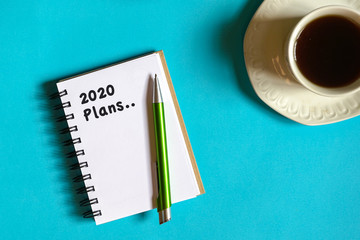 2020 new year goal, plan, action text on note pad. Top view or flat lay.
