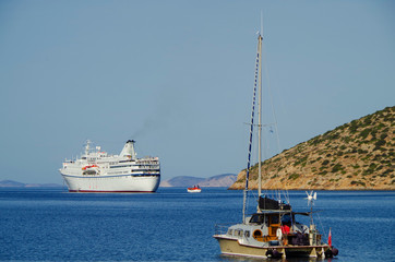 Classic small cruise ship MS Ocean Majesty anchoring in bay on blue sea of Greek Island during...