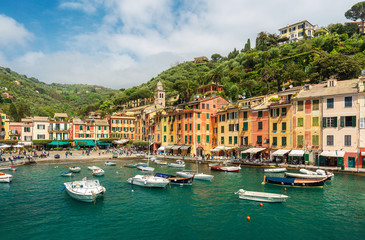 Beautiful Portofino in Italy with colorful houses and villas, fishing boats in the little bay harbor - Liguria, Italian destinations, Europe