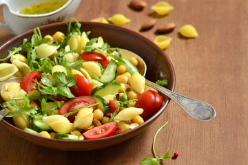 Mediterranean pasta salad with vegetables and chickpeas, copy space