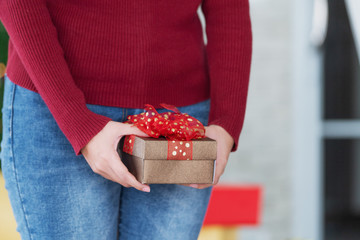 Woman in red sweater holding gift box, Special occasions gift