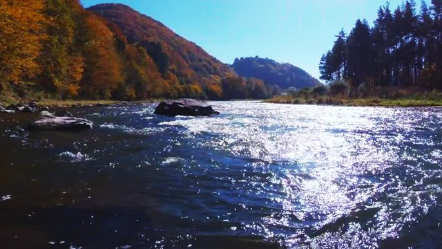 Poprad River in sunny autumn day. Rytro, Poland.