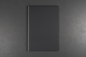 Empty black book on grey background