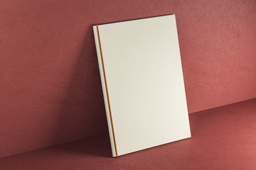 Empty white textbook on red background