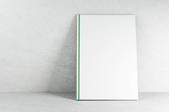 Empty white book on concrete wallpaper