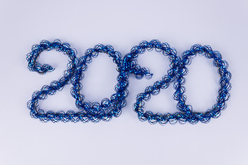 numbers two thousand twenty, from a decorative blue rain highlighted in closeup, on a white background.
