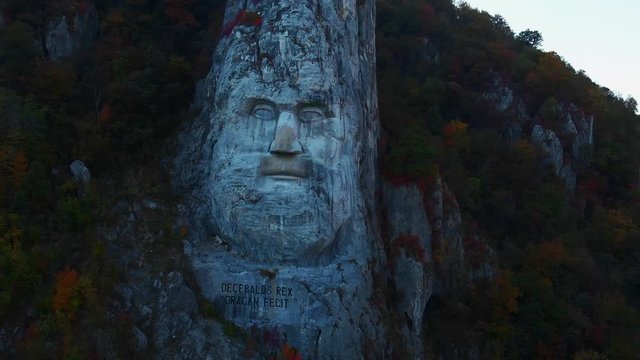 Statue of Decebalus, biggest stone statue in Europe, aerial close-up and reveal of danube valley.