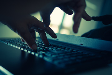 hacker or cyber crime hand reaching, stealing information on laptop, attack signifying internet...