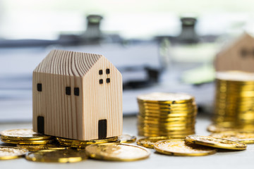 Home real estate mortgage concept : House miniature model with stack money coins show for selling....