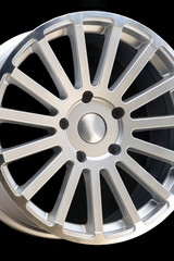 new vehicle rims made from aluminum alloy, multi-spoke silver wheel, close-up on a black background