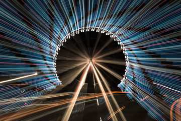 Long exposure zoom of a ferris wheel at night