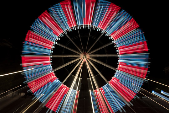 Long Exposure Zoom Of A Ferris Wheel At Night