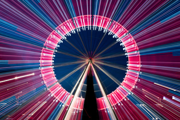 Long exposure zoom of a ferris wheel at night