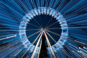 Long exposure zoom of a ferris wheel at night