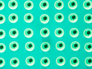 Fototapeta premium Green eyes pattern on green background