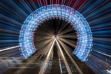 Long exposure zoom of a ferris wheel at night