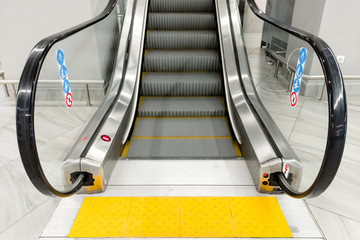 modern people-free escalator with tiles for the blind