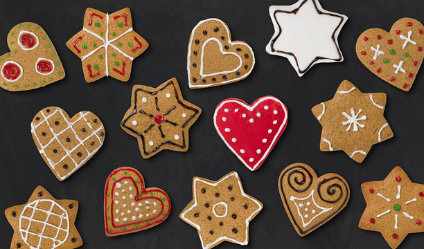 Several gingerbread hearts and stars on a dark background