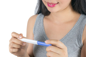 Young asian woman with pregnancy midstream test in hands isolated on white background. fertility or maternity concept