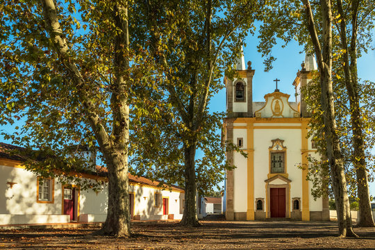 Late afternoon view of Our Lord Jesus of the Afflicted Hermitage, framed by trees, near Portalegre in Portugal.