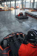 Fototapeta premium Racer in helmet driving go kart car