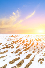 Muddy dirt road covered with snow in the countryside