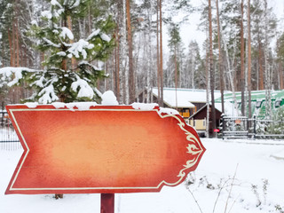 An blank information pointer in park, from wood, indicating the direction