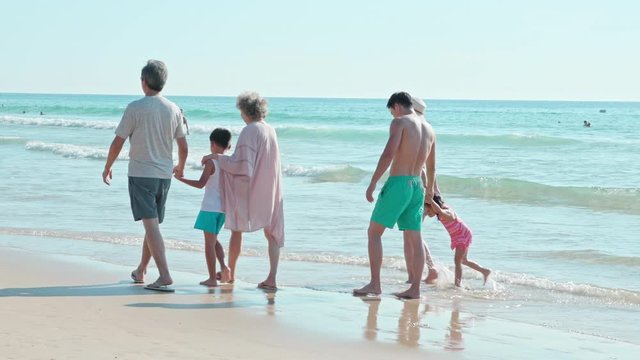 Happy family walking on beach,4K