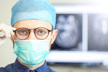 Portrait of a surgeon doctor in uniform at the medical office.