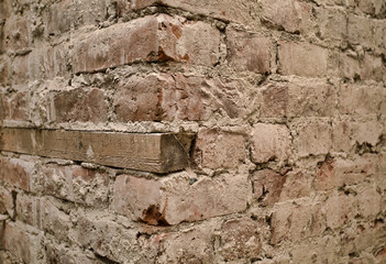 Old brick wall with wooden mortgage.