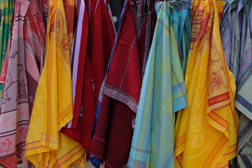 A row of brightly colored cotton kitchen towels.