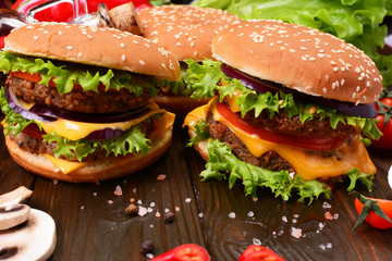 Hamburgers of the best products on a wooden background