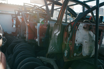 Car parts and tires on junkyard, nobody