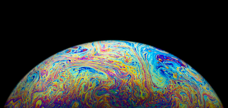 Close up picture of psychedelic soap bubble on black background