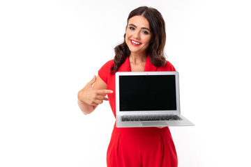 A young woman with red lips, bright makeup, works with a white laptop and shows something on screen, picture isolated on white background