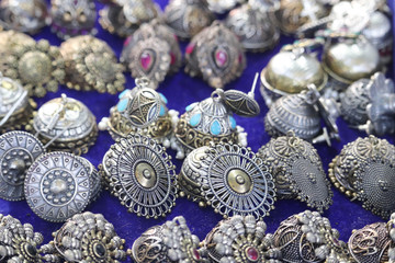 Selective Focus On Designer Ear Rings Jewelry Or Jewellery Ornaments On Blue Background