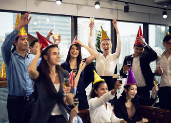 Close-up smiling Businesspeople on New Year Party in Office and celebrating of New Year small group.