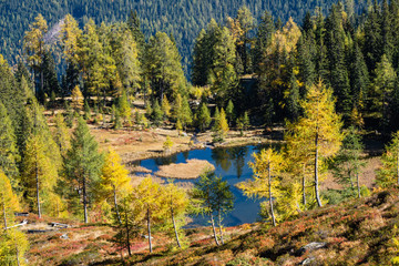 Calm autumn Alps mountain lake with clear transparent water and reflections. Untersee lake, Reiteralm, Steiermark, Austria.