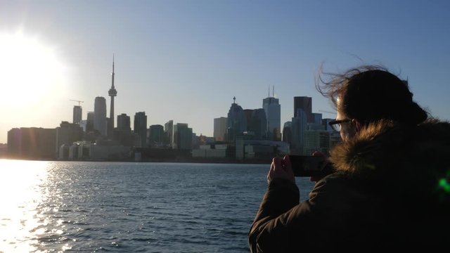 Photographer taking photo of Toronto with mobile smart phone 2