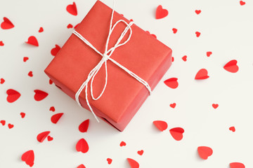 Saint Valentine day. Top view of red gift box on heart pattern white background.