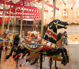 Fototapeta na wymiar Historic carousel from early 20th century gifts fun and joy to modern people.