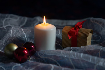 Candle, gift box and Christmas tree decorations
