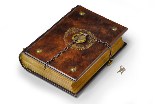 Brown leather book with metal pins in the corners, the gilded symbol and padlock with chain to lock the book