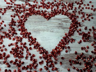  close-up of a large juicy burgundy sweet ripe pomegranate from which the heart is made