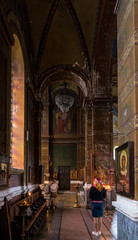 Believer stands and prays in the Holy Mother Virgin Nativity Cathedral in Batumi city - the capital of Adjara in Georgia