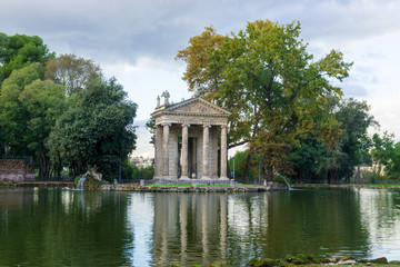 Fototapeta na wymiar Temple of Aesculapius (19th century) in the public park Pincian Hill, Villa Borghese gardens, Rome, Italy