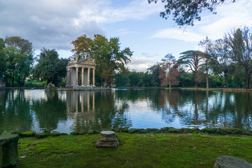 Fototapeta na wymiar Temple of Aesculapius (19th century) in the public park Pincian Hill, Villa Borghese gardens, Rome, Italy