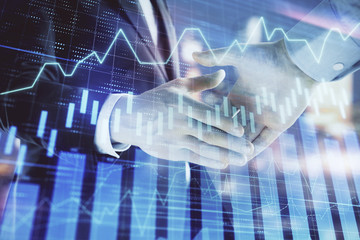 Plakat Double exposure of financial chart on cityscape background with two businessmen handshake. Concept of financial analysis and investment opportunities