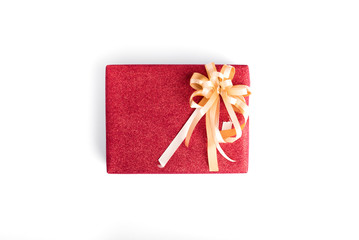 The Christmas present with red glitter gift wrapping and gold ribbon isolated on white background.